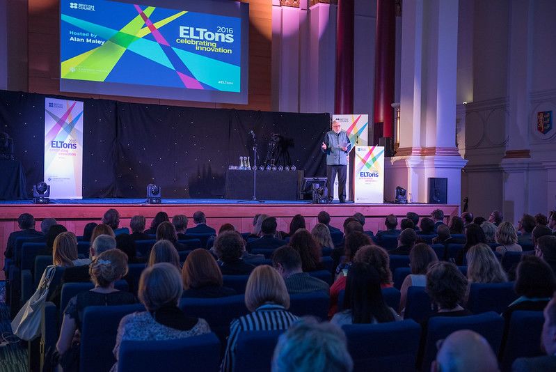 A large audience watching someone give a presentation on stage at ELTons.
