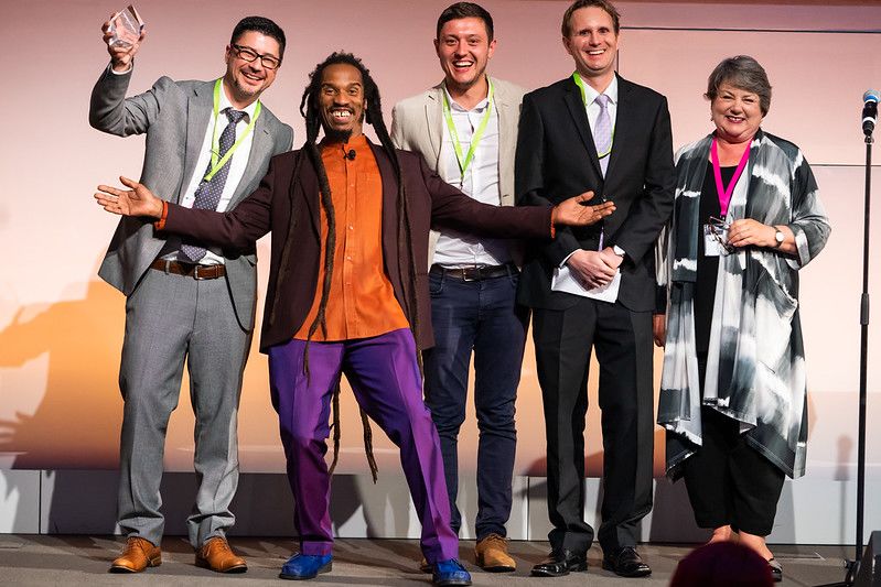 Benjamin Zephaniah with ELTons winners on stage.