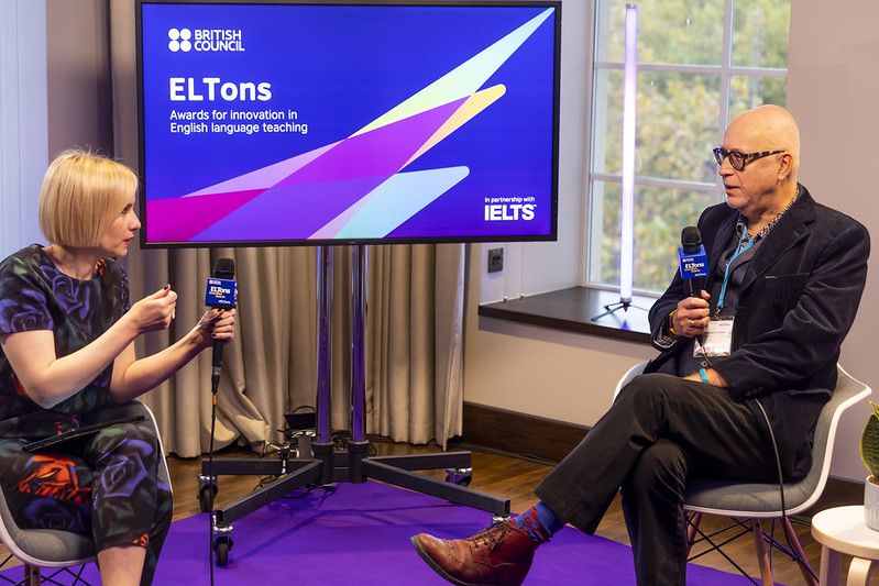 Two people at ELTons speaking to each other with microphones.