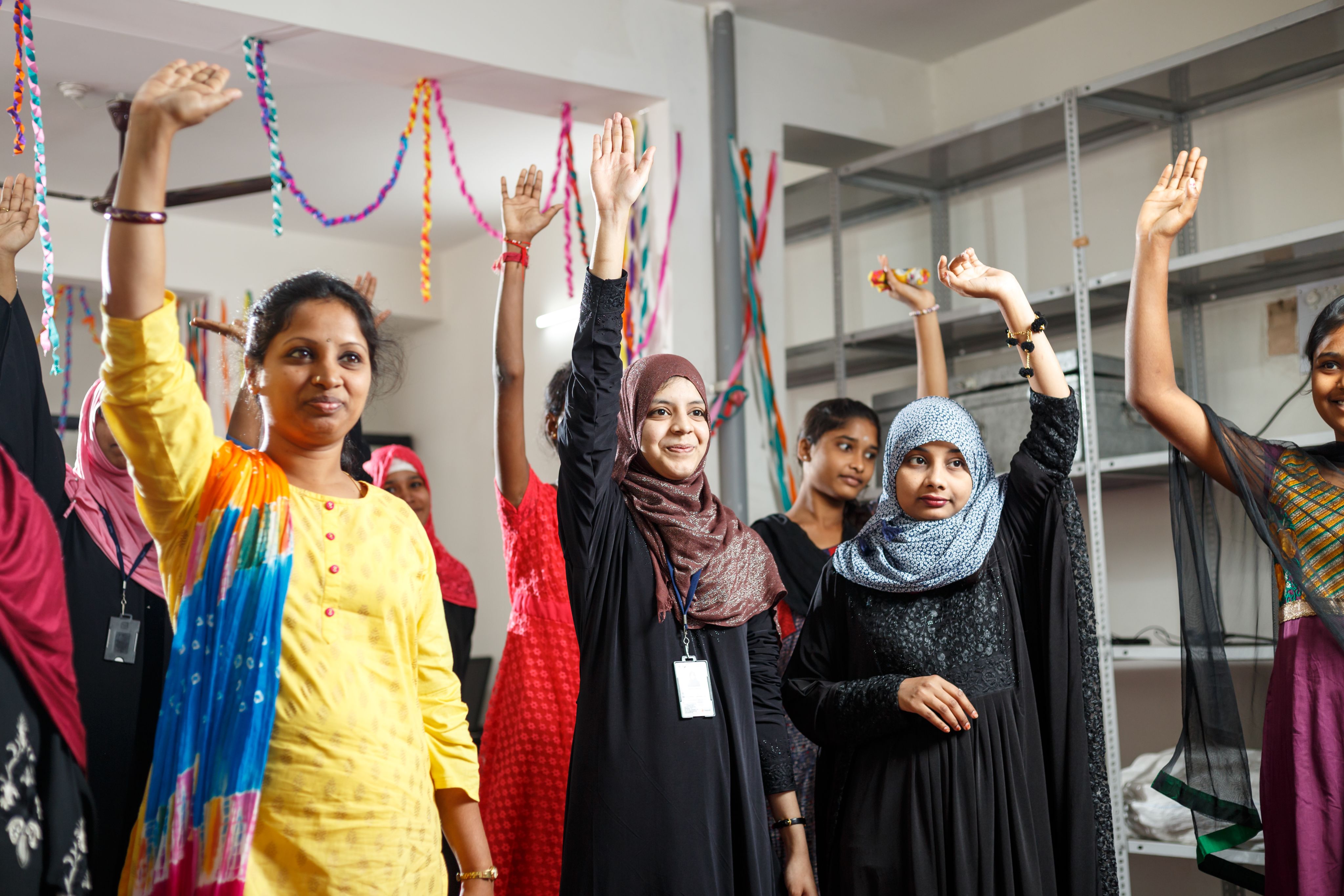 EDGE club members with their hands raised.
