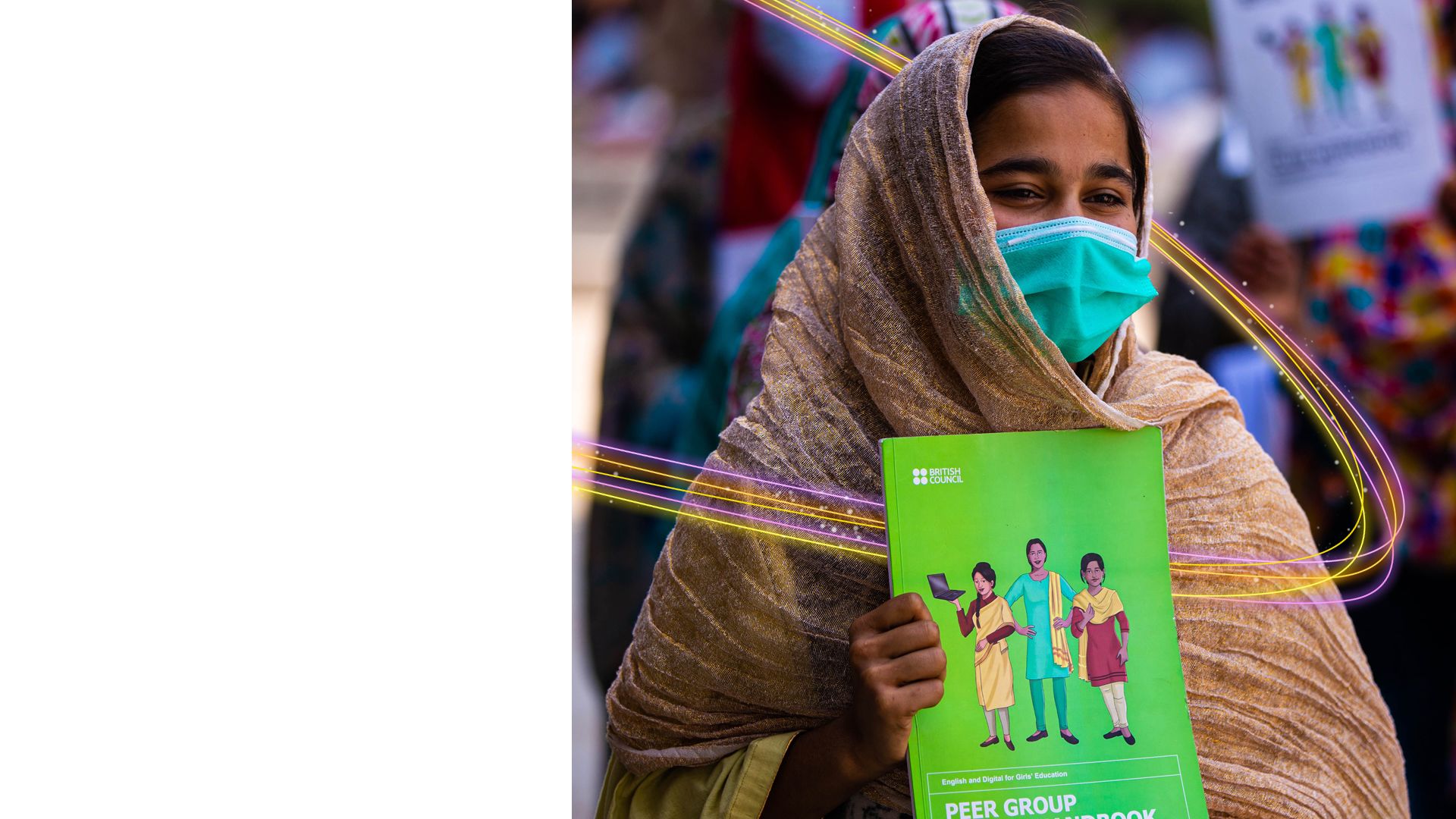 A smiling teenage girl holding an EDGE workbook for Peer Group Leaders.